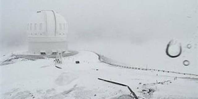 This webcam image shows the CFHT telescope on the summit of Mauna Kea on Hawaii's Big Island covered in snow on Dec. 1, 2016.