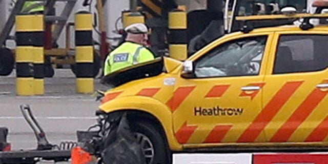 Emergency personnel are seen attending to one of the vehicles involved in a crash early on Wednesday morning.