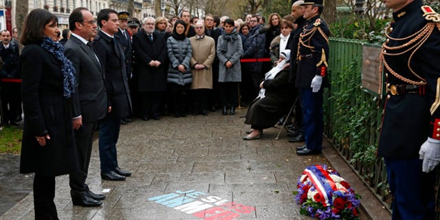 Jan. 5, 2016: French President Francois Hollande, second left, Paris mayor Anne Hidalgo, left, and Prime Minister Manuel Valls unveil a plaque honoring policeman Ahmed Merabet is pictured in Paris.