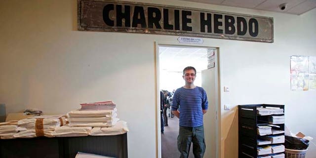 French cartoonist Charb, publishing director of French satirical weekly Charlie Hebdo, poses for photographs at their offices in Paris, September 19, 2012. Charlie Hebdo published cartoons of the Prophet Mohammad on Wednesday, a decision criticised by the French authorities which sent riot police to protect the magazine's offices. REUTERS/Jacky Naegelen (FRANCE - Tags: MEDIA CIVIL UNREST POLITICS RELIGION TPX IMAGES OF THE DAY) - RTR3853H