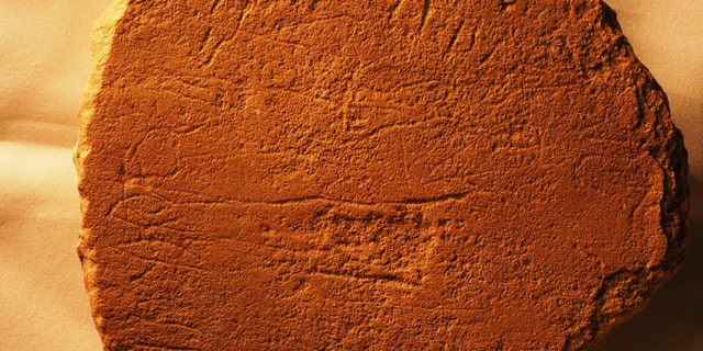 A photo of Sinai 375a, a stone slab from Egypt, which is now located in the Harvard Semitic Museum. This photo contains the name Ahisamach (Exodus 31:6) on the two horizontal lines. (Credit: Douglas Petrovich)