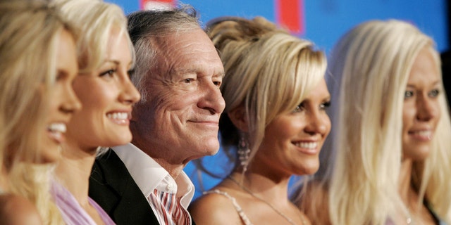 Playboy founder Hugh Hefner and his three girlfriends Holly Madison (2nd L), Bridget Marquardt (2nd R) and Kendra Wilkinson (R) arrive at the E! Entertainment television summer splash party at the Tropicana bar at the Roosevelt hotel in Hollywood, Aug. 1, 2005.