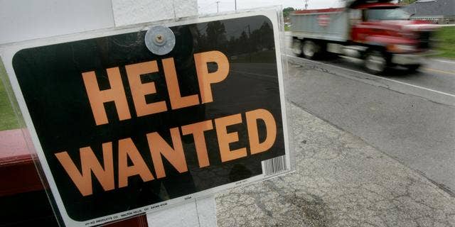 A landscaping company looks for help with a sign hung along a busy roadway in Chesterland, Ohio on Friday, June 3, 2005. Job growth slowed nearly to a crawl in May, with new hiring registering the smallest gain in two years, the Labor Department reported Friday.(AP Photo/Amy Sancetta)