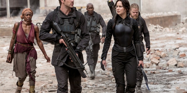 Jennifer Lawrence portrays Katniss Everdeen, right, and Liam Hemsworth portrays Gale Hawthorne in a scene from "The Hunger Games: Mockingjay Part 1."