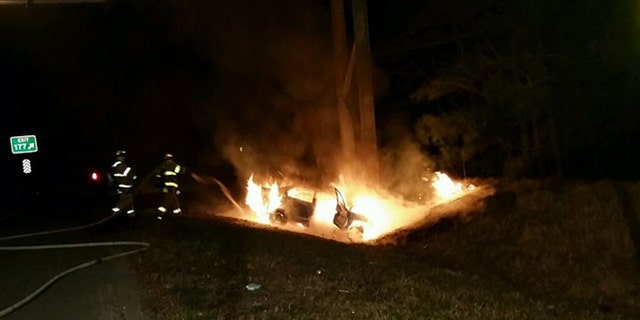 Firefighters extinguish fire on I-64 Saturday after Good Samaritan's dramatic rescue. (Henrico County Division of Fire)