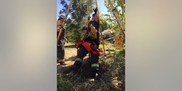Rescuers being lowered into the drain on May 1.