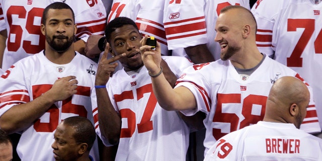 Jan. 31, 2012: New York Giants linebacker Spencer Paysinger (55), Jacquian Williams (57) and Mark Herzlich (58) have some fun during Media Day for NFL football's Super Bowl XLVI in Indianapolis.