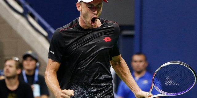 John Millman, of Australia, reacts after winning a point against Roger Federer, of Switzerland.