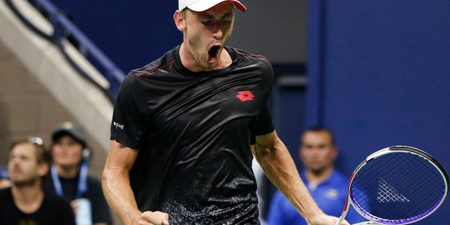 John Millman, of Australia, reacts after winning a point against Roger Federer, of Switzerland.