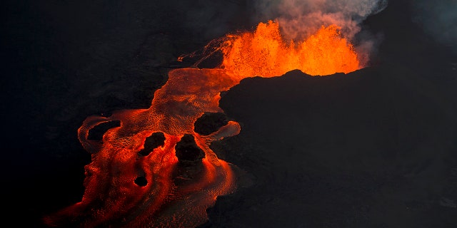 Lava from the Kilauea volcano continues to erupt from a fissure and forms a river of lava flowing down to Kapoho.