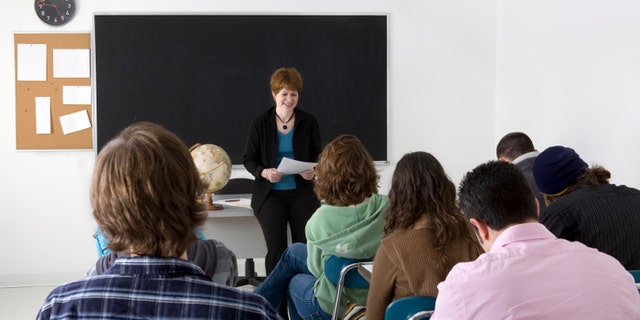 A teacher conducting a high school class.