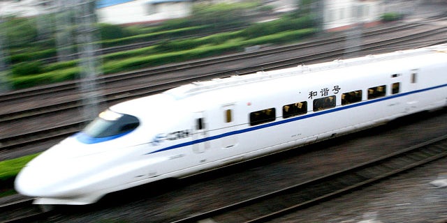 In this photo released by China's Xinhua News Agency, a train with a speed of 200 kph (124 mph) leaves Shanghai bound for Suzhou, in China, Wednesday, April 18, 2007. Chinese trains running at up to 200 kph (124 mph) began service on Wednesday as part of a new bid to keep up with ballooning transport demand, state media reported. The first of scores of high-speed trains left Shanghai at 5:38 a.m. (2138 GMT) Wednesday morning for the nearby city of Suzhou, covering the approximately 85 kilometers (53 miles) in about 39 minutes, the Xinhua News Agency reported. (AP Photo/Xinhua, Chen Fei)