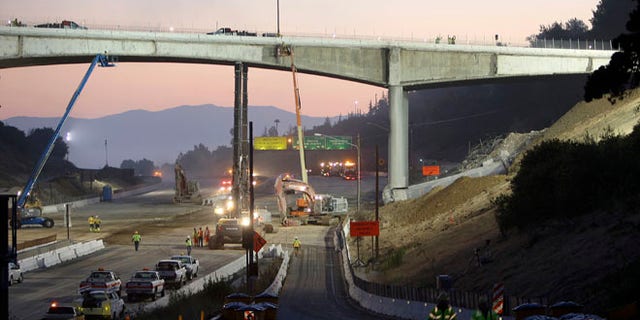 FILE: 2011: Workers demolish the Mulholland Drive bridge across the 405 freeway in Los Angeles, Calif.