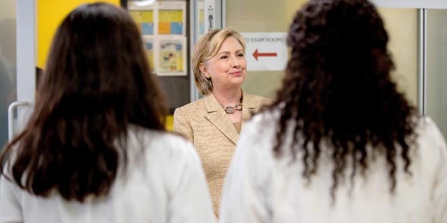 Democratic presidential candidate Hillary Clinton meets with doctors as she takes a tour of Borinquen Health Care Center, in Miami, Tuesday, Aug. 9, 2016, to see how they are combatting Zika. The center is within and serves the current area identified by the CDC where the Zika virus is being spread by mosquitos. (AP Photo/Andrew Harnik)