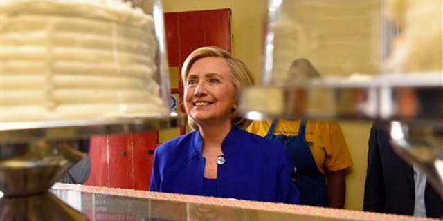Democratic presidential candidate, former U.S. Secretary of State Hillary Rodham Clinton leaves The Main Street Bakery after speaking to Frederic Hunt, minister of the First Calvary Baptist Church, Wednesday , May 27, 2015, in Columbia, S.C. (AP Photo/Richard Shiro)