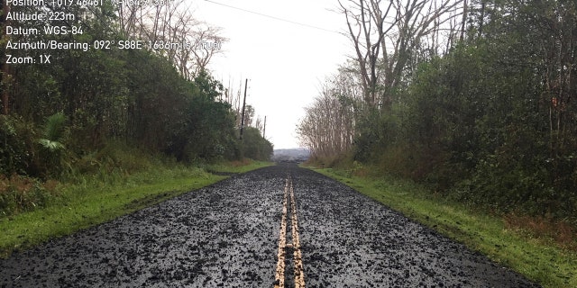 This Tuesday, May 29, 2018 photo provided by the U.S. Geological Survey shows what is known as tephra, airborne lava fragments, erupted by the high lava fountains of fissure 8 was carried downwind, where the frothy rock fragments fell on Leilani Street, just past Kupono Street, in the Leilani Estates subdivision.