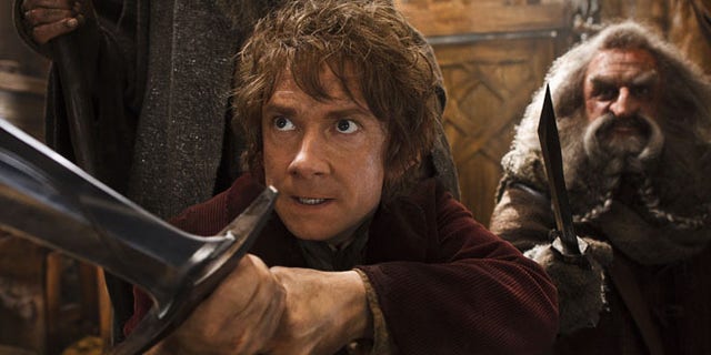 This image released by Warner Bros. Pictures shows Martin Freeman, left, and John Callen in a scene from "The Hobbit: The Desolation of Smaug." The Hobbit: The Desolation of Smaug held off Anchorman 2 on a busy weekend at the box office. According to studio estimates Sunday, Peter Jacksons Hobbit sequel took in $31.5 million in its second weekend of release. That topped Will Ferrells Anchorman sequel, which nevertheless opened strongly in second place.