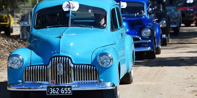 Historic Holdens parading through Adelaide.