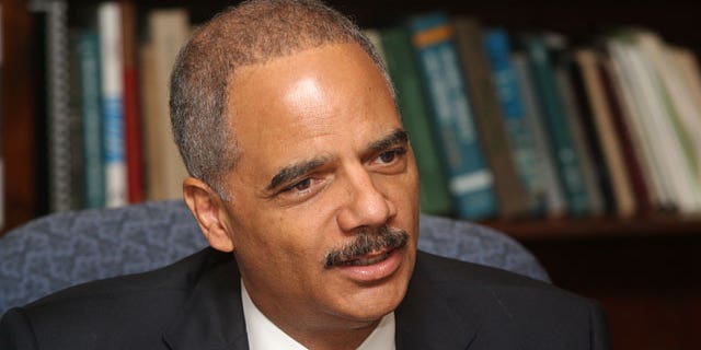Attorney General Eric Holder talks with local businessmen Thursday, June 30, 2011 at the Alabama Department of Marine Resources & Conservation on Dauphin Island, Ala.