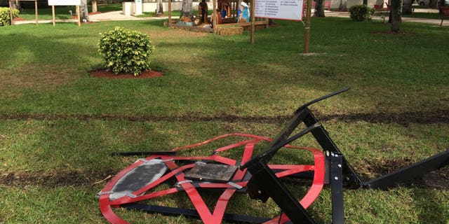 A satanic pentagram erected by atheist Preston Smith lies damaged in Boca Raton's Sanborn Square, Fla. on Tuesday, Dec. 20, 2016.