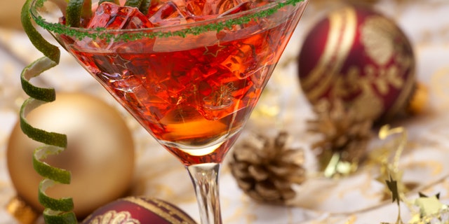 Glass of Christmas Cocktail in martini glass and Christmas ornaments