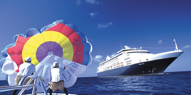 Guests can get the excitement of being in the air, with the view of the ship and the beach, while parasailing from Half Moon Cay.