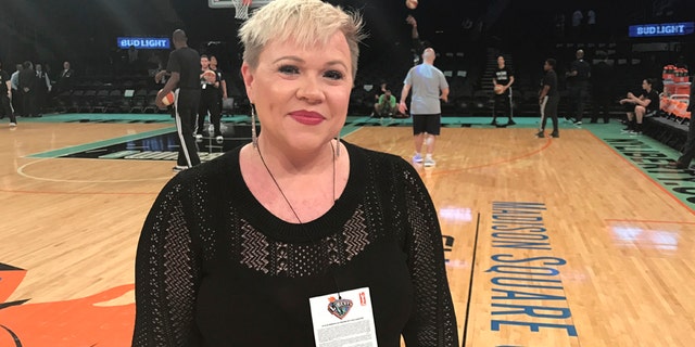 Holly Rowe stands on the court at Madison Square Garden in New York before a WNBA basketball game between the New York Liberty and the Minnesota Lynx, Thursday, May 18, 2017.