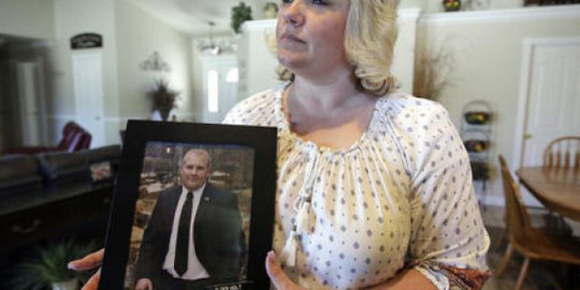 FILE - In this July 30, 2016, file photo, Laurie Holt, the mother of Josh Holt, an American jailed in Venezuela, cries during a rally at the Utah State Capitol, in Salt Lake City.