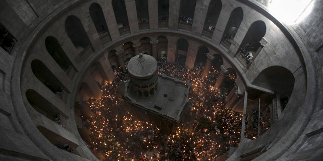 File photo - Worshippers hold candles as they take part in the Christian Orthodox Holy Fire ceremony at the Church of the Holy Sepulchre in Jerusalem's Old City April 11, 2015. (REUTERS/Baz Ratner)