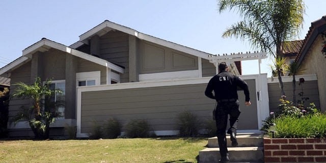 FILE: A Huntington Beach police Crime Scene Investigator is shown at the family home of Denise Huskins in Huntington Beach, California