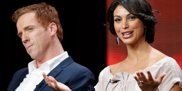 July 30, 2012. Cast member Morena Baccarin speaks, as co-star Damian Lewis watches, at a panel for "Homeland" during the Showtime television portion of the Television Critics Association Summer press tour in Beverly Hills, California.