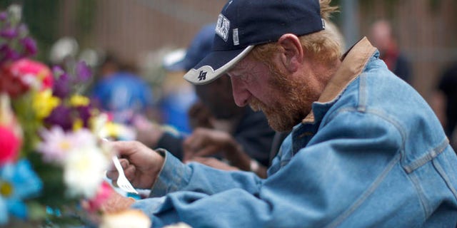 April 18, 2014: A man receives a meal at an event to help the homeless and near-homeless of Skid Row.