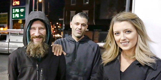 When Kate McClure, right, ran out of gas, Johnny Bobbitt Jr., left, who is homeless, gave his last $20 to buy gas for her. McClure, seen with boyfriend Mark D'Amico, middle, started a Gofundme.com campaign for Bobbitt that has raised more than $13,000. (Elizabeth Robertson/The Philadelphia Inquirer via AP)