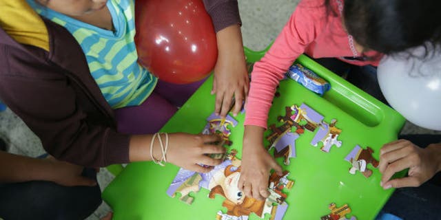 Children deported from the U.S. play after arriving at Ramon Villeda international airport in San Pedro Sula, in this July 14, 2014 handout provided by the Honduran Presidential House. REUTERS/Presidential House/Handout via Reuters