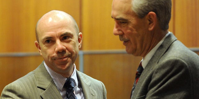 Feb. 21: Tina Watson's father, Tommy Thomas, right, greets dive master Wade Singleton after Singleton testified in the murder trial of Gabe Watson.