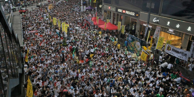 July 1, 2014: Tens of thousands of people fill in a street during a march at an annual protest in downtown Hong Kong.
