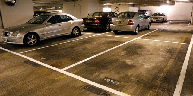 Cars are parked near empty spots at a residential building in Hong Kong Tuesday, Nov. 27, 2012.