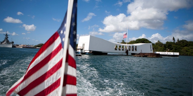 FILE - This Dec. 7, 2011 file photo shows the USS Arizona Memorial in Pearl Harbor, Hawaii. This popular site at Pearl Harbor is actually a grave, a resting place for crew members who died in the Pearl Harbor attack of Dec. 7, 1941. Visitors can see it on a first-come, first-serve basis, and many do to see a significant piece of history and pay respects to those who died. (AP Photo/Marco Garcia, file)