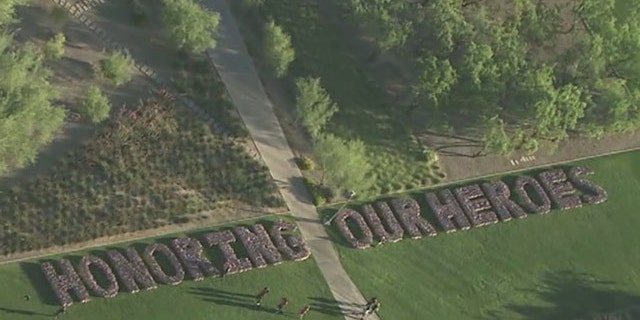 Volunteers are plan 10,000 flags at the University of Phoenix as a Memorial Day tribute.