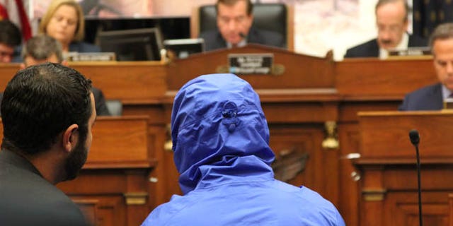 July 31, 2014: A Syrian defector who goes only by the name 'Caesar,' and who wore a hood to obscure his face, testifies before the House Foreign Affairs Committee.