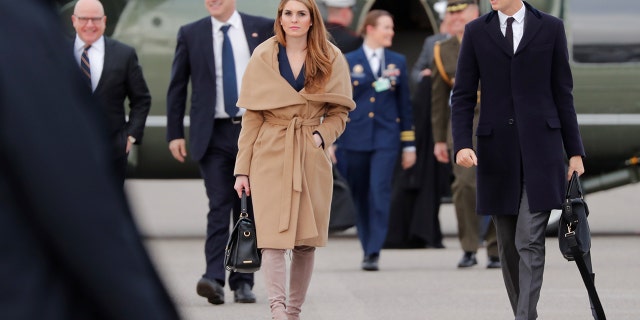 The White House communications director stunned in a pair of taupe suede, thigh-high Stuart Weitzman boots, priced at $798, and a navy blue wrap dress.