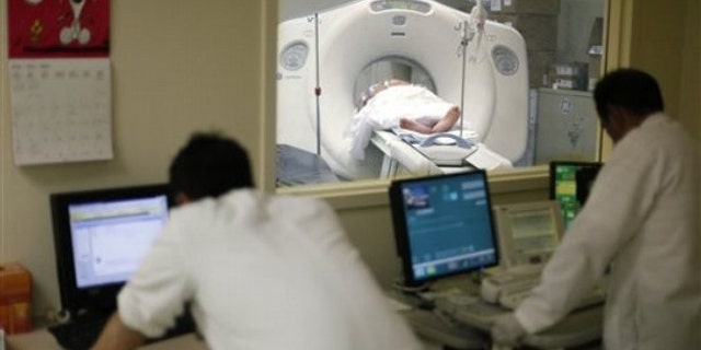 In this May 4 photo, a CT is performed on a patient at Cook County Stroger Hospital in Chicago.