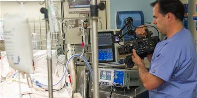 Feb. 23, 2015: In this photo, Dr. Angelo Volandes films a patient at Straub Clinic and Hospital in Honolulu, for videos he develops that educate families about end-of-life care options, such as CPR.