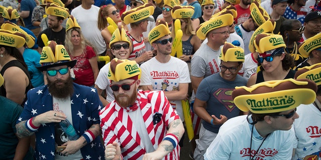 The July 4th event attracts thousands of spectators at New York's Coney Island boardwalk.