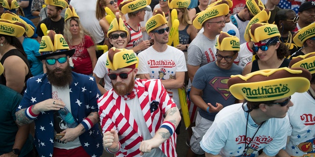 The July 4th event attracts thousands of spectators at New York's Coney Island boardwalk.