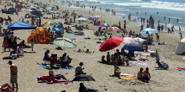 March 14, 2015: Crowds line the shore at Manhattan Beach, Calif., as a late winter heat wave sent temperatures soaring in Southern California.
