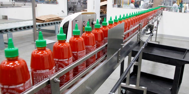 Oct. 29, 2013: This photo shows Sriracha chili sauce moves along a production line during at the Huy Fong Foods factory in Irwindale, Calif.