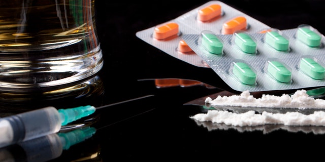 drugs and pills on black background with reflection