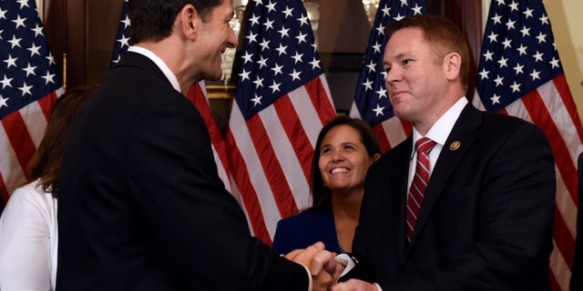June 9, 2016: House Speaker Paul Ryan of Wis., left, shakes hands with Rep.-elect Warren Davidson, R-Ohio, right, before Davidson is officially sworn in on Capitol Hill in Washington.