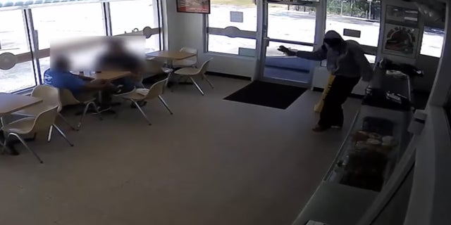 The robbery suspect hand-delivered crullers to a couple of customers.